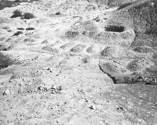 Black and white image of covered graves