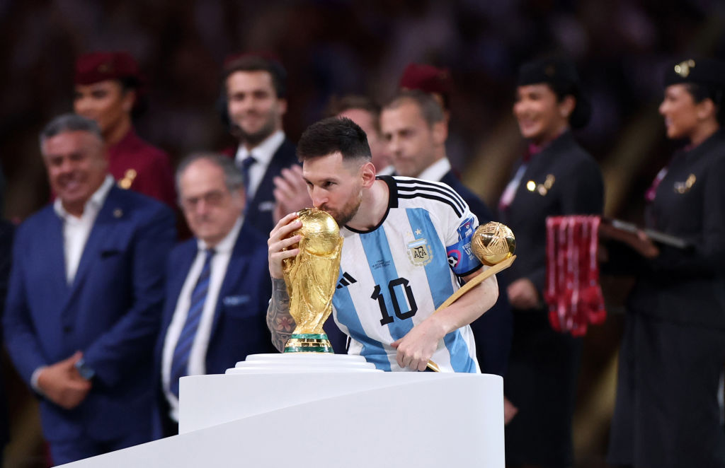 Lionel Messi kissing the World Cup trophy at the 2022 FIFA World Cup