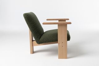 Armchair with wooden frame and green upholstered seat and back