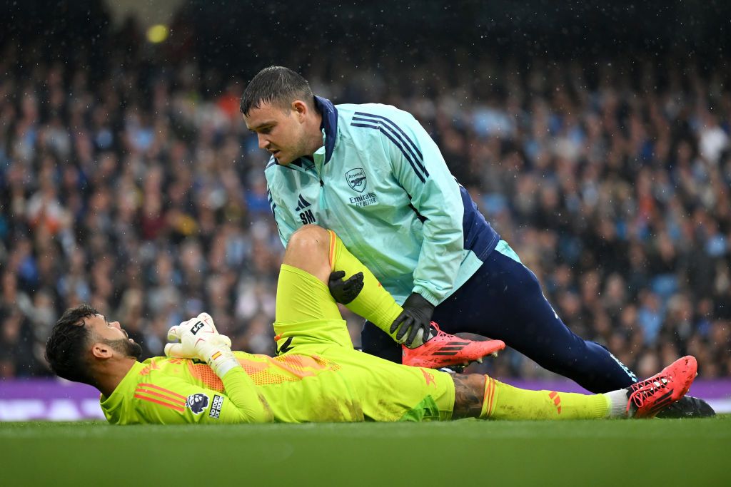 David Raya of Arsenal receives medical treatment during the Premier League match between Manchester City FC and Arsenal FC at Etihad Stadium on September 22, 2024 in Manchester, England.