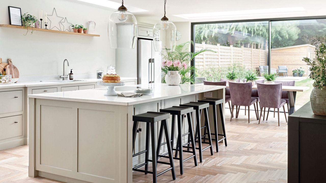 Wood herringbone flooring in white kitchen