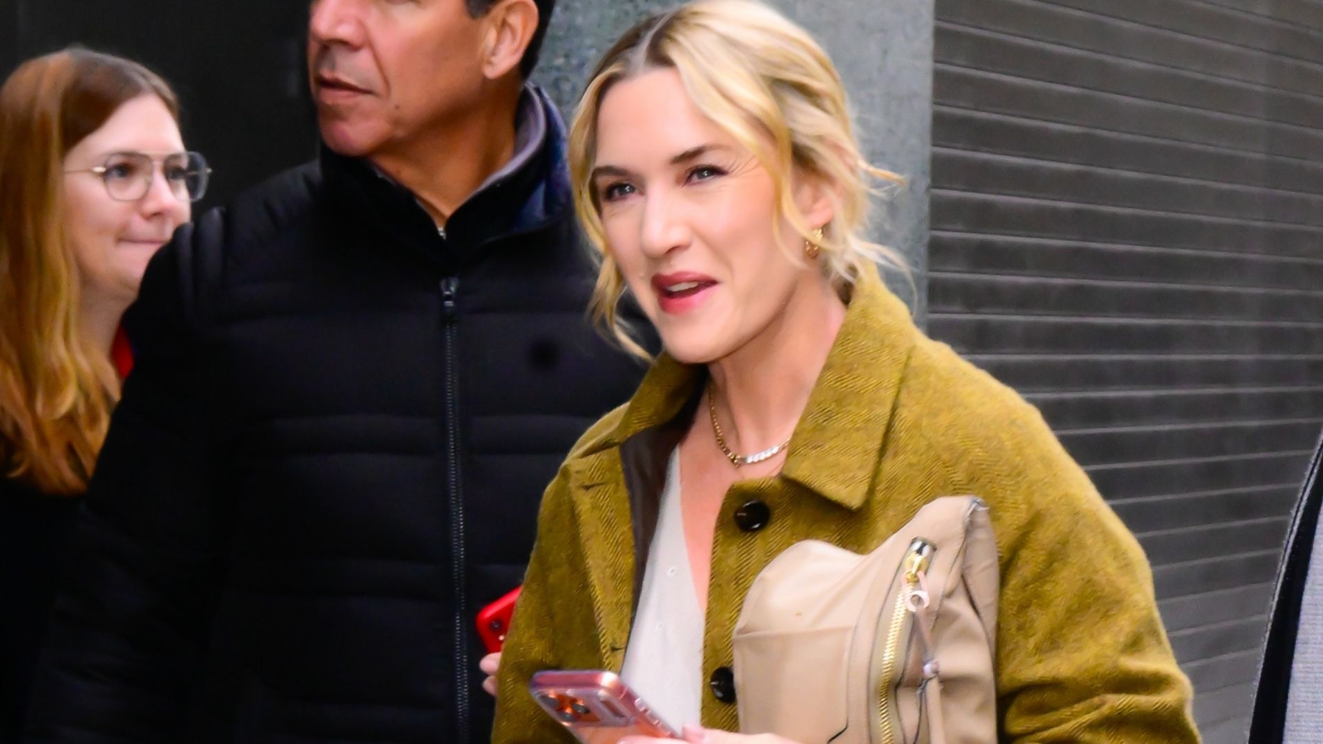 Kate Winslet wears a green coat