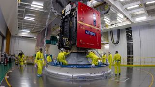 After its arrival in the final assembly building on April 1, 2023, ESA’s Jupiter Icy Moons Explorer (JUICE) spacecraft was slowly lifted into the air and then carefully lowered onto the top of the Ariane 5 rocket that will launch it into space on April 13. Here we see technicians working atop the rocket, bolting down JUICE launch vehicle adapter to keep it secure during launch.