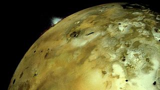 a plume is seen on the horizon of a greenish-yellow and brown moon