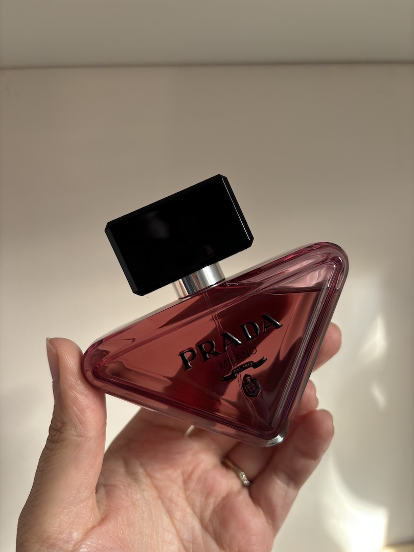Mica Ricketts holding bottle of Prada Paradoxe Sweet Chemistry