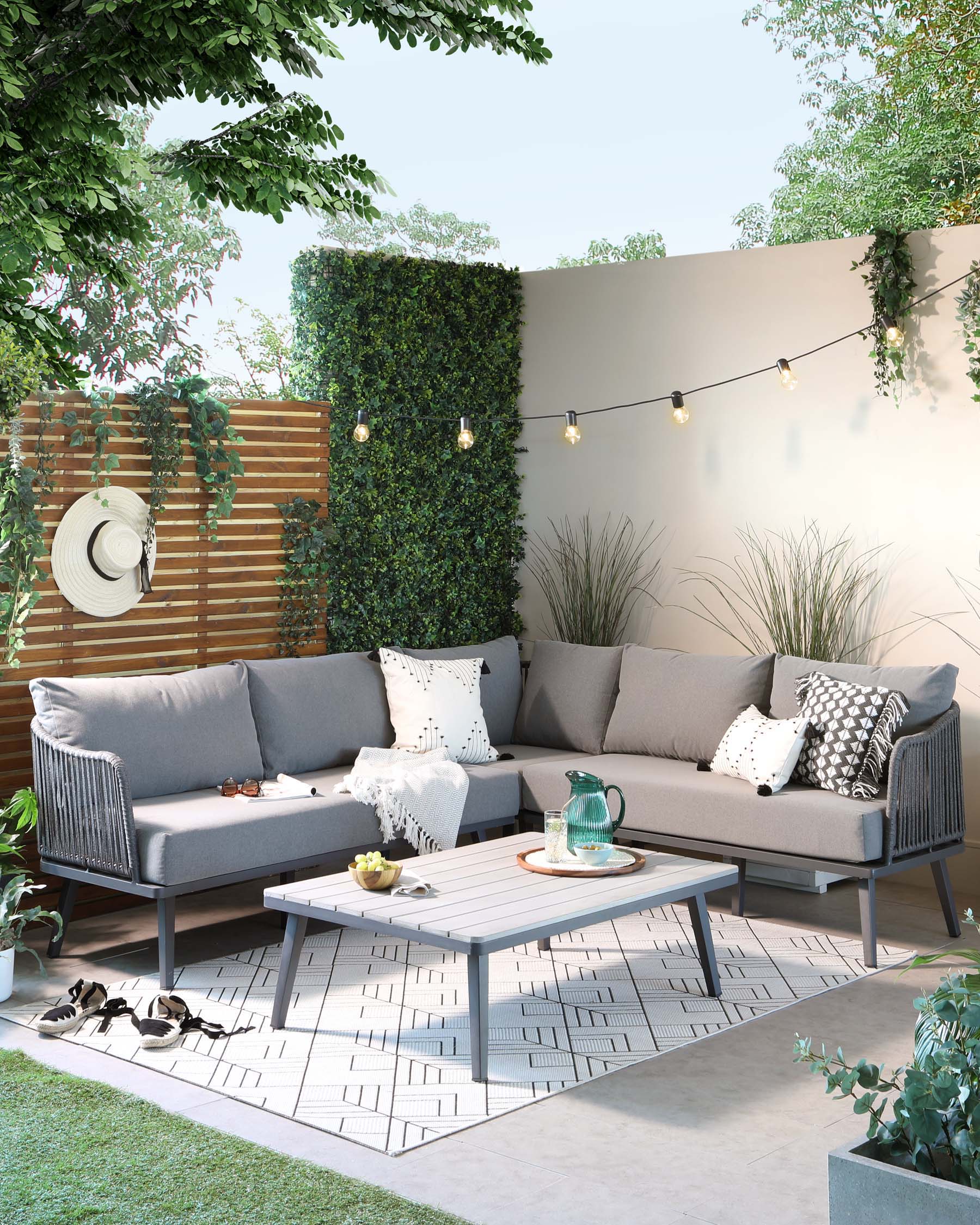 small modern courtyard garden seating area with festoon lights