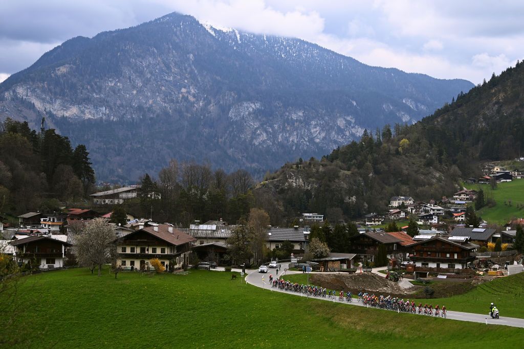 ALPBACH AUSTRIA APRIL 17 A general view of the peloton passing through a Brixlegg village with mountainous landscape during the 46th Tour of the Alps 2023 Stage 1 a 1275km stage from Rattenberg to Alpbach 984m on April 17 2023 in Alpbach Austria Photo by Tim de WaeleGetty Images