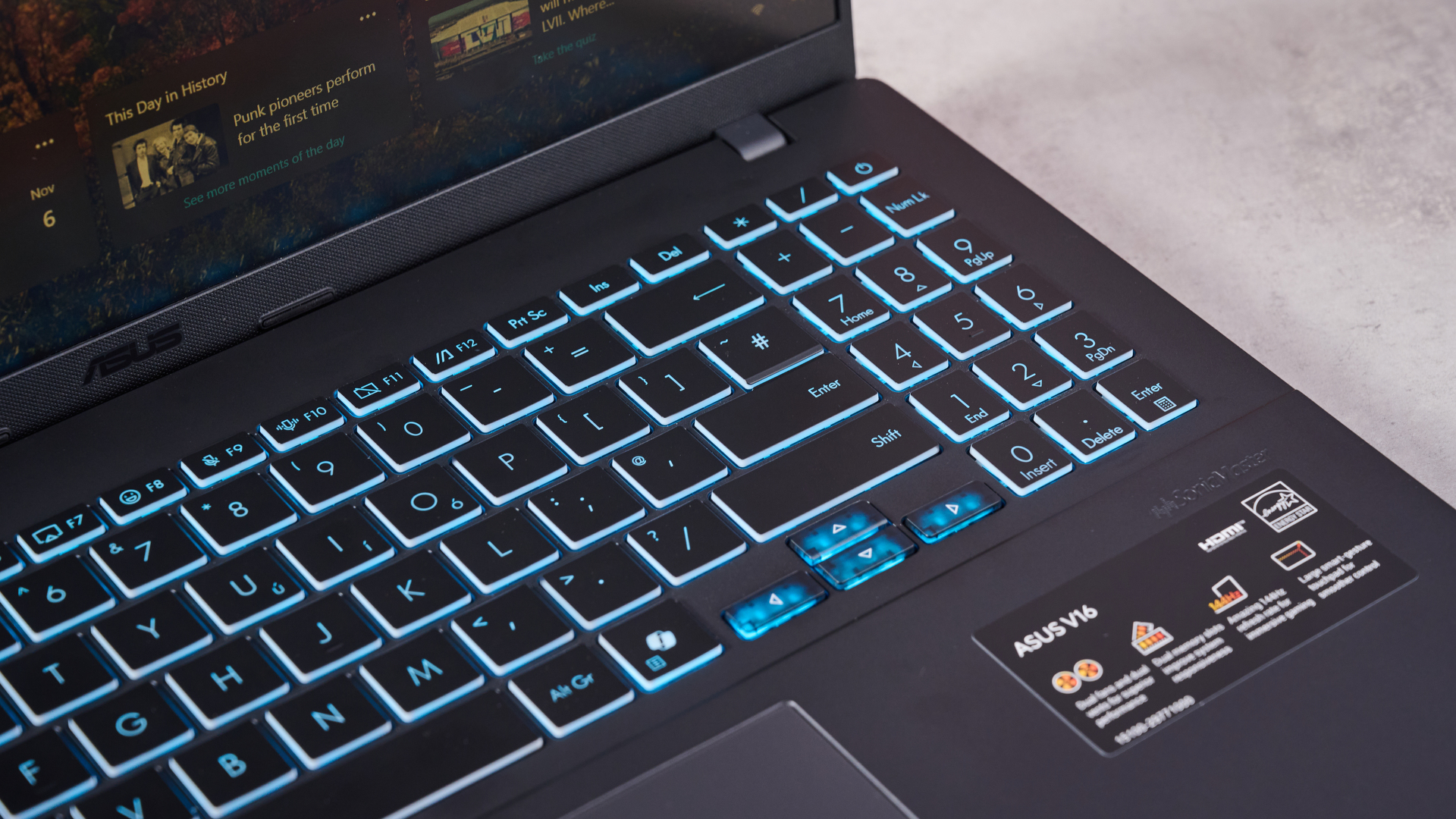 Close-up of right side of keyboard with blue backlighting on Asus V16