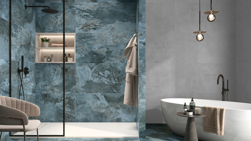 Blue bathroom idea with marble-style tiles in a shower and free-standing bath to the right hand side