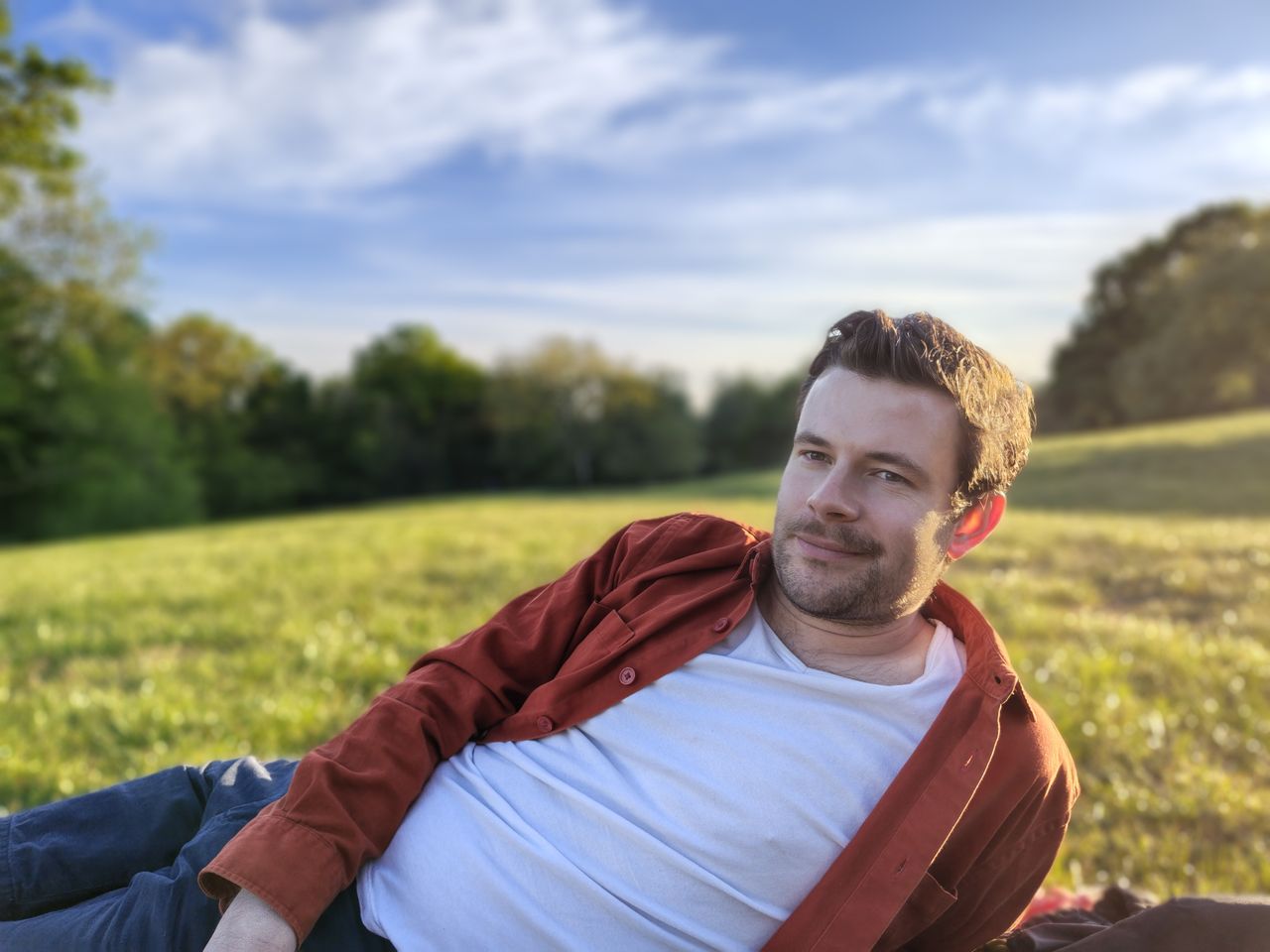 A camera sample taken on the Motorola Edge 70 Fusion, showing a man lying on a field