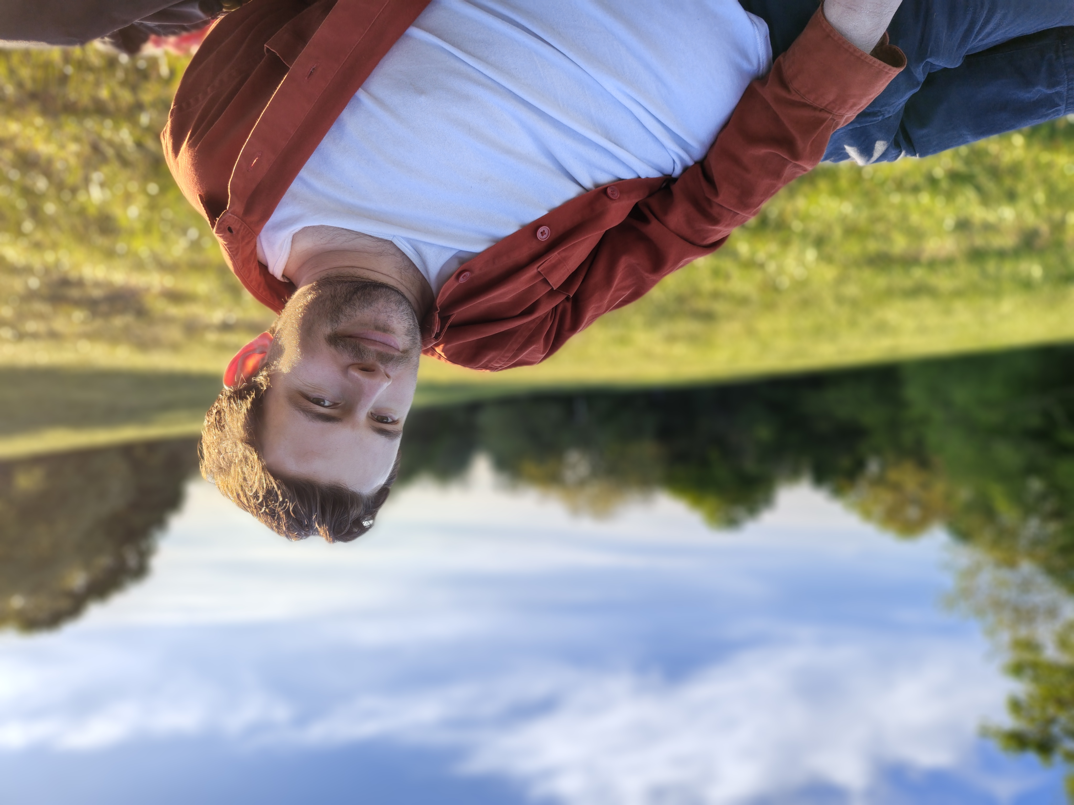 A camera sample taken on the Motorola Edge 70 Fusion, showing a man lying on a field
