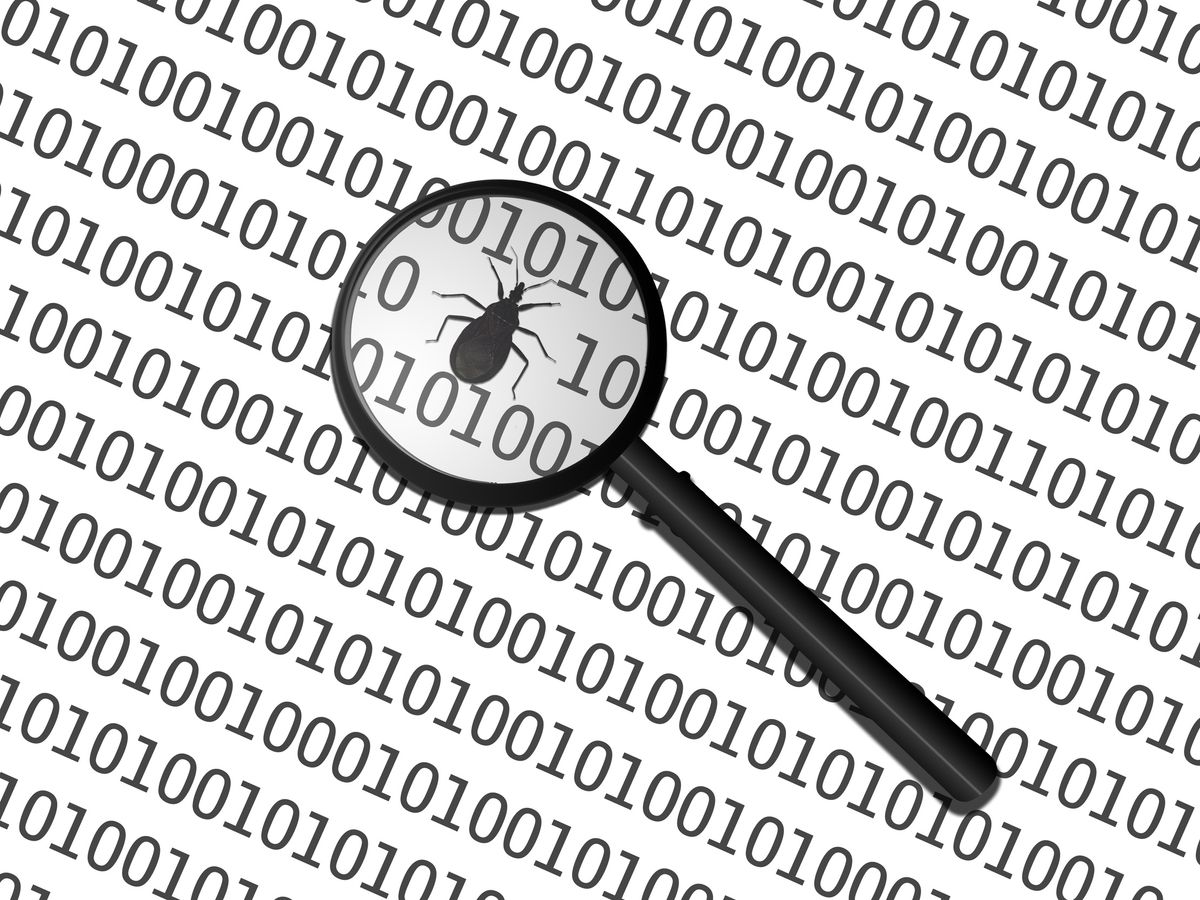 magnifying glass showing bug on binary code