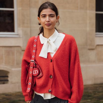 woman wearing red cardigan with white button-down shirt 