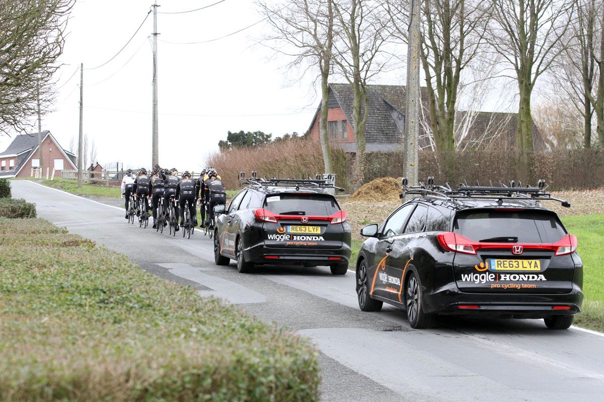 The team cars follow the training ride