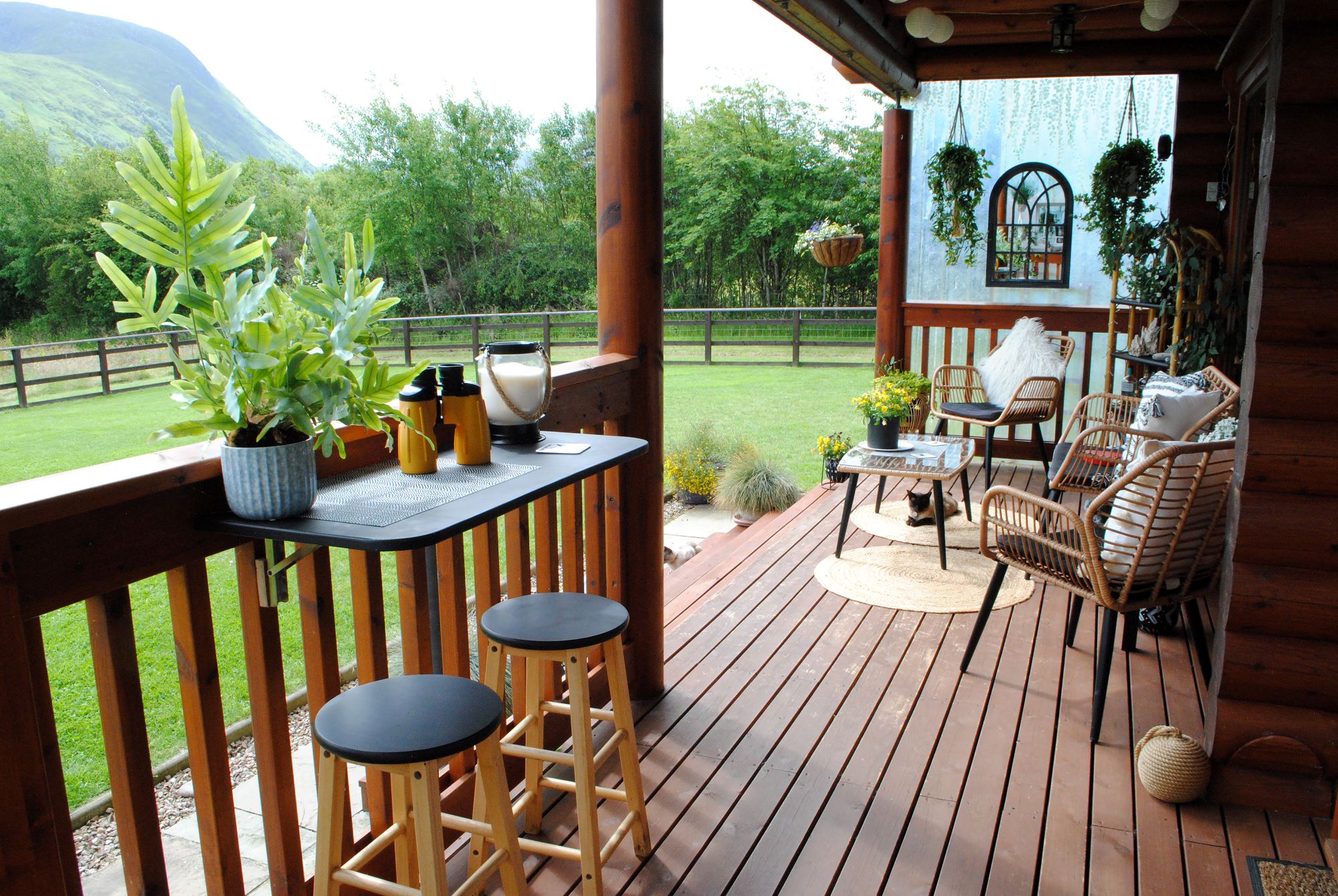 The timber porch looks out onto the front garden and has decorative chairs