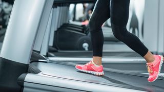 Feet walking on a treadmill, trying the 12-3-30 TikTok treadmill workout