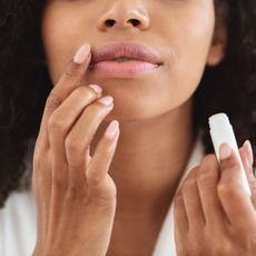 Close up of woman applying lip balm