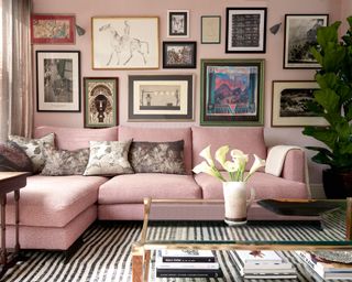 Pink living room with gallery wall with striped rug
