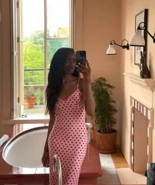 Influencer wears a Reformation dress.