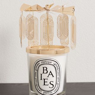 A Diptyque Carousel and Baies scented candle