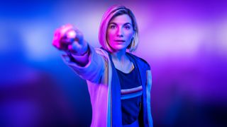 Jodie Whittaker holds a sonic screwdriver up to the camera as the 13th Doctor.
