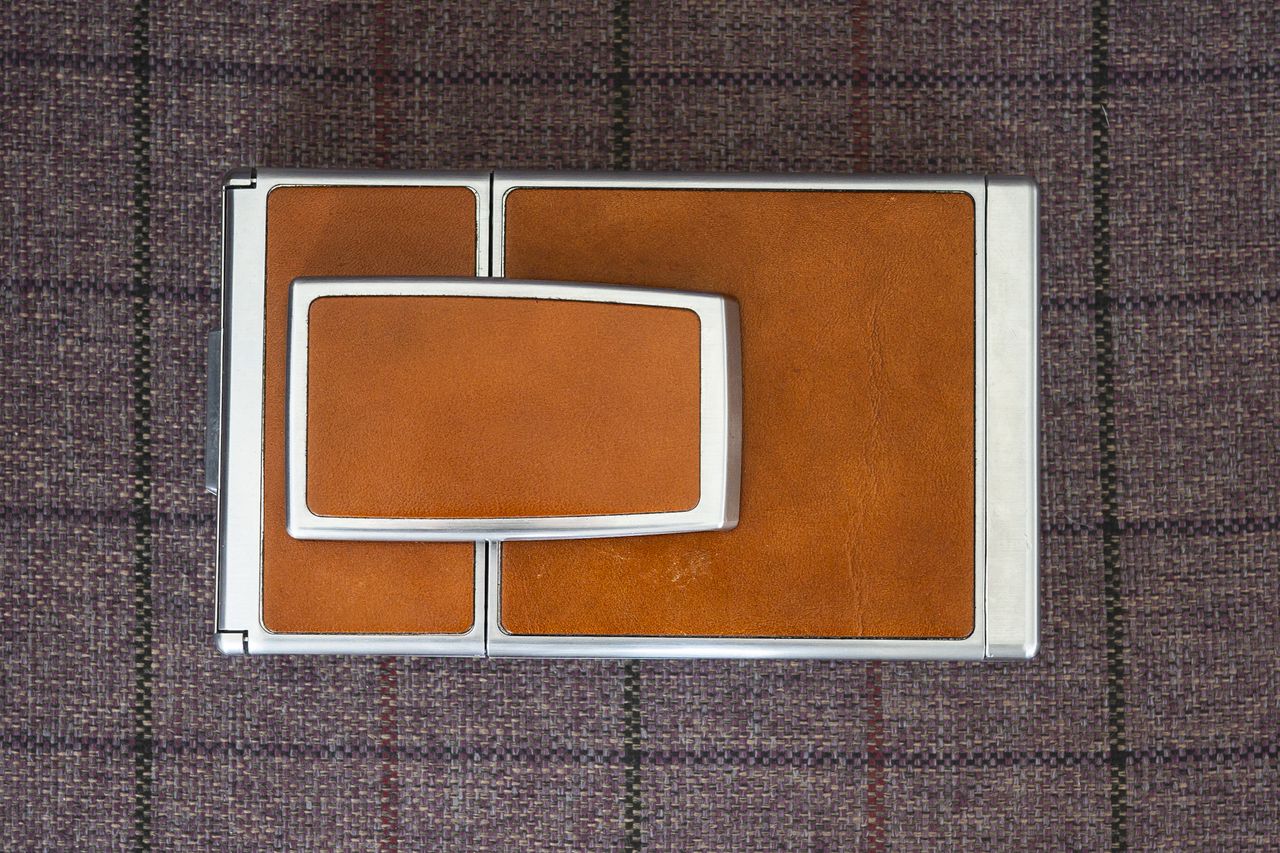 Polaroid SX70 camera top view in closed position on purple chair