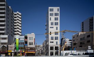 A photo of a street featuring the Tatsumi Apartment House.