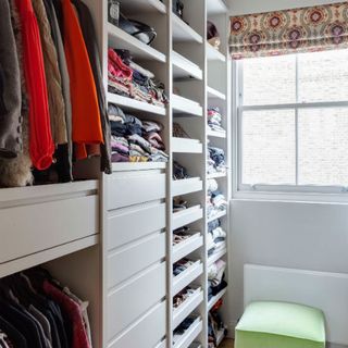 built in wardrobe with stacked shelves and configuration of drawers and shelves