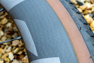 A close up of the dimpled sidewalls on a carbon bicycle wheel