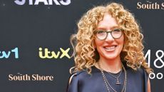 KELLY HOPPEN WEARING A NAVY DRESS