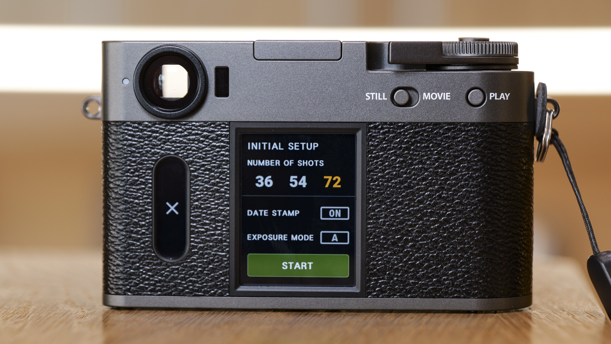 Fujifilm X half compact camera's back, on a wooden surface