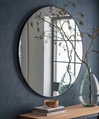 round mirror and a side table