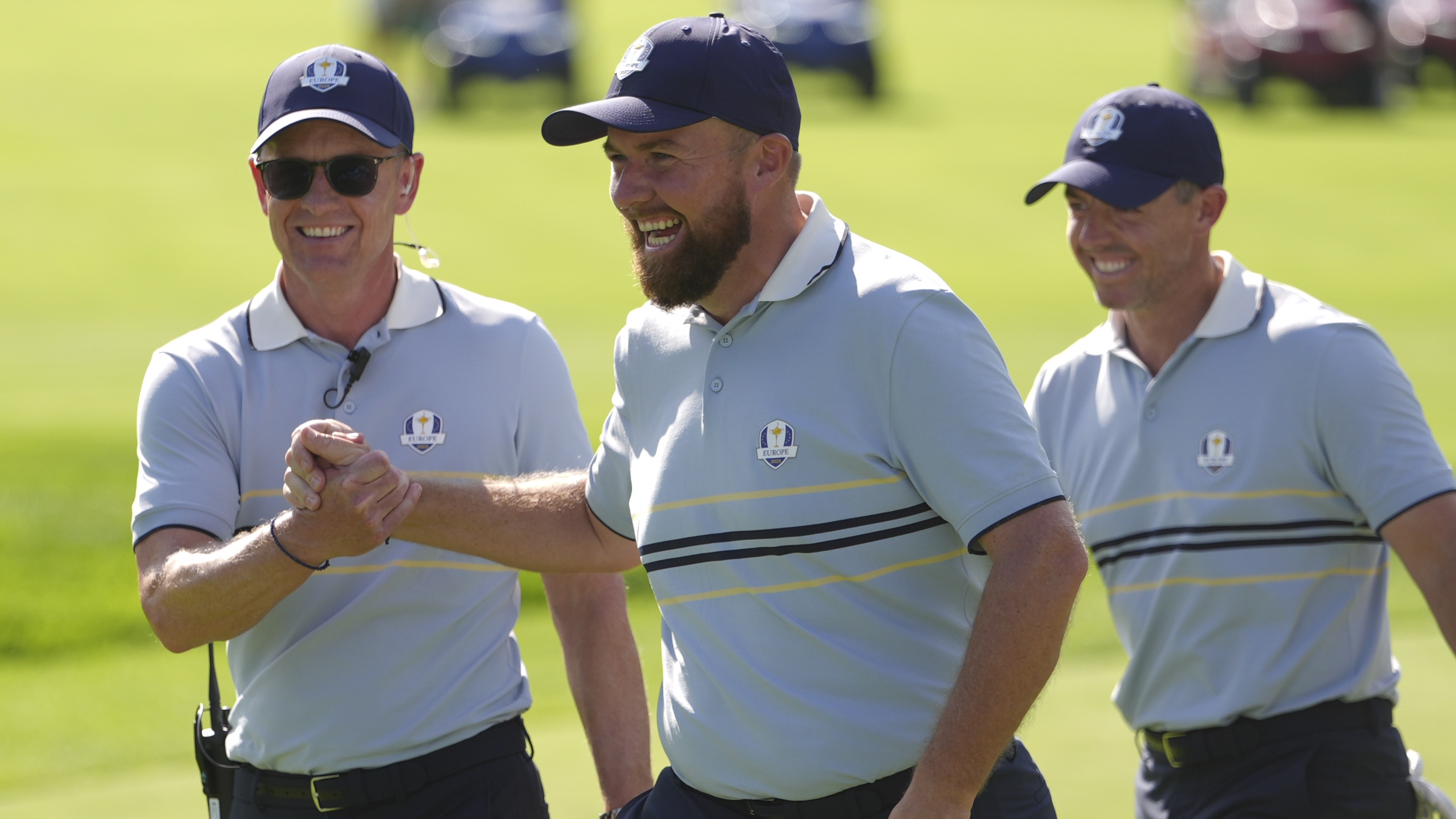 Captain Luke Donald, Shane Lowry, and Rory McIlroy of Team Europe react on the seventh hole green during the 2025 Ryder Cup on the Black Course at Bethpage State Park on Friday, September 26, 2025 in Farmingdale, New York.