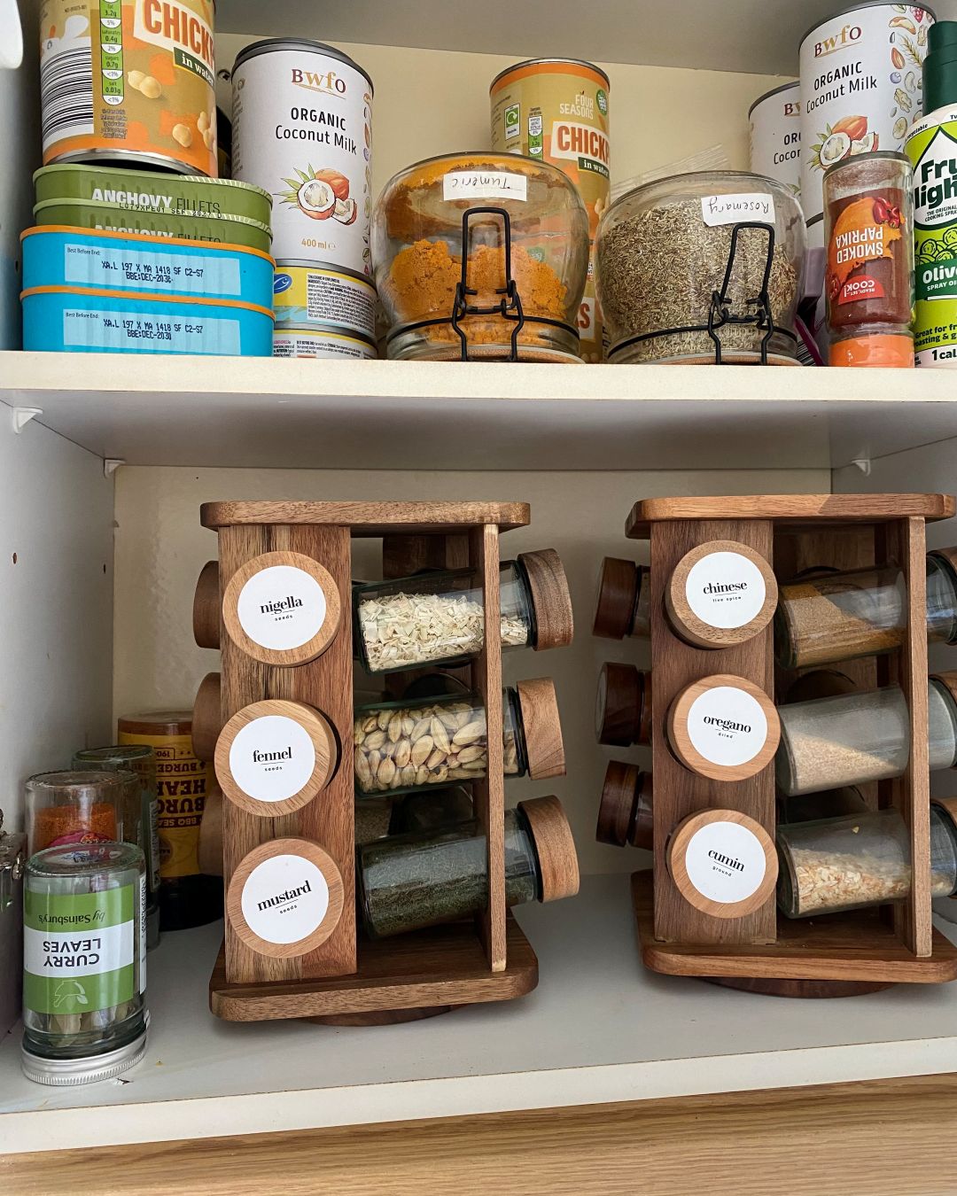 Cupboard with spice racks and spice jars placed upside down