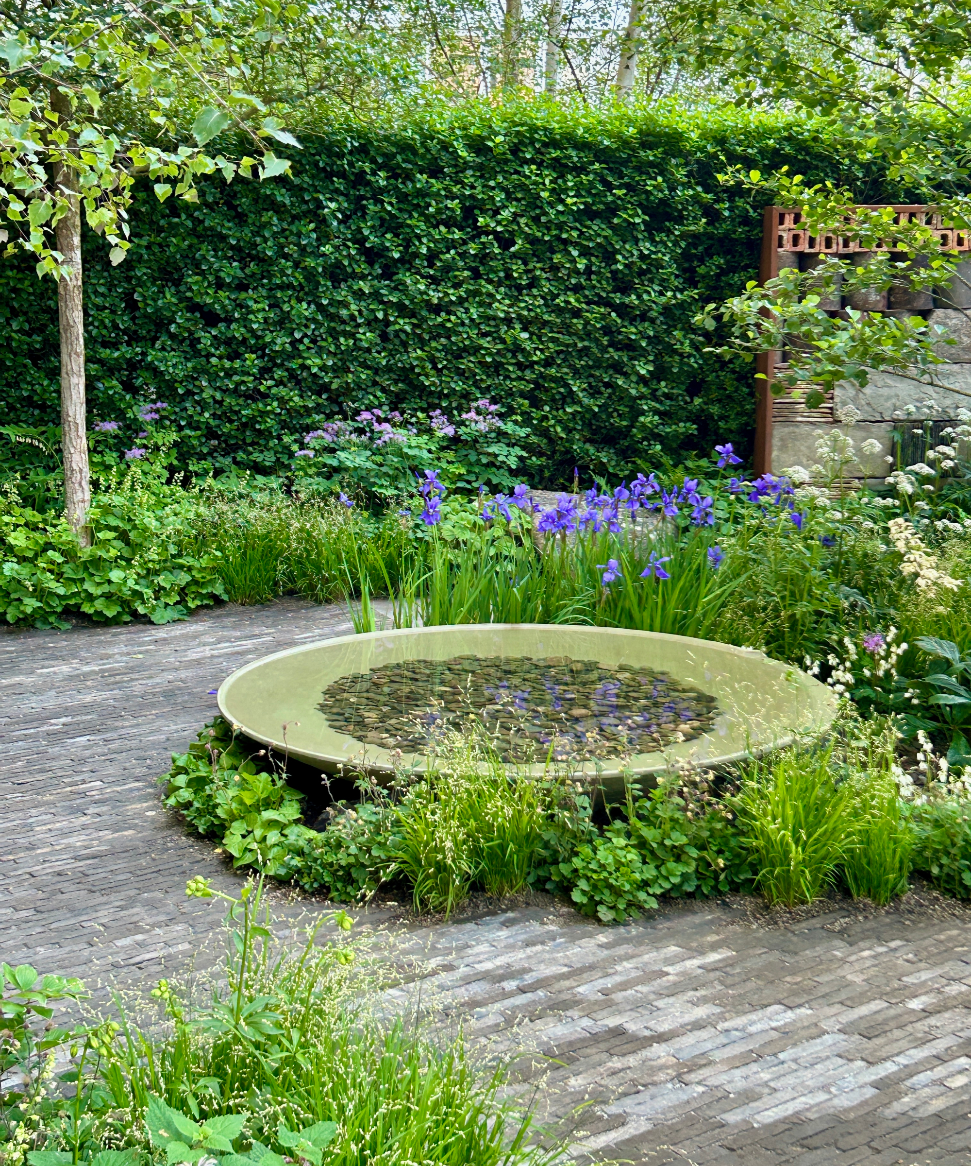 large water bowl and water feature in a professionally landscaped garden