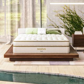 Saatva Classic Mattress in luxury bedroom on wooden bed frame
