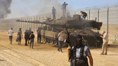 Hamas fighters destroy an Israeli tank in Gaza City on 7 October