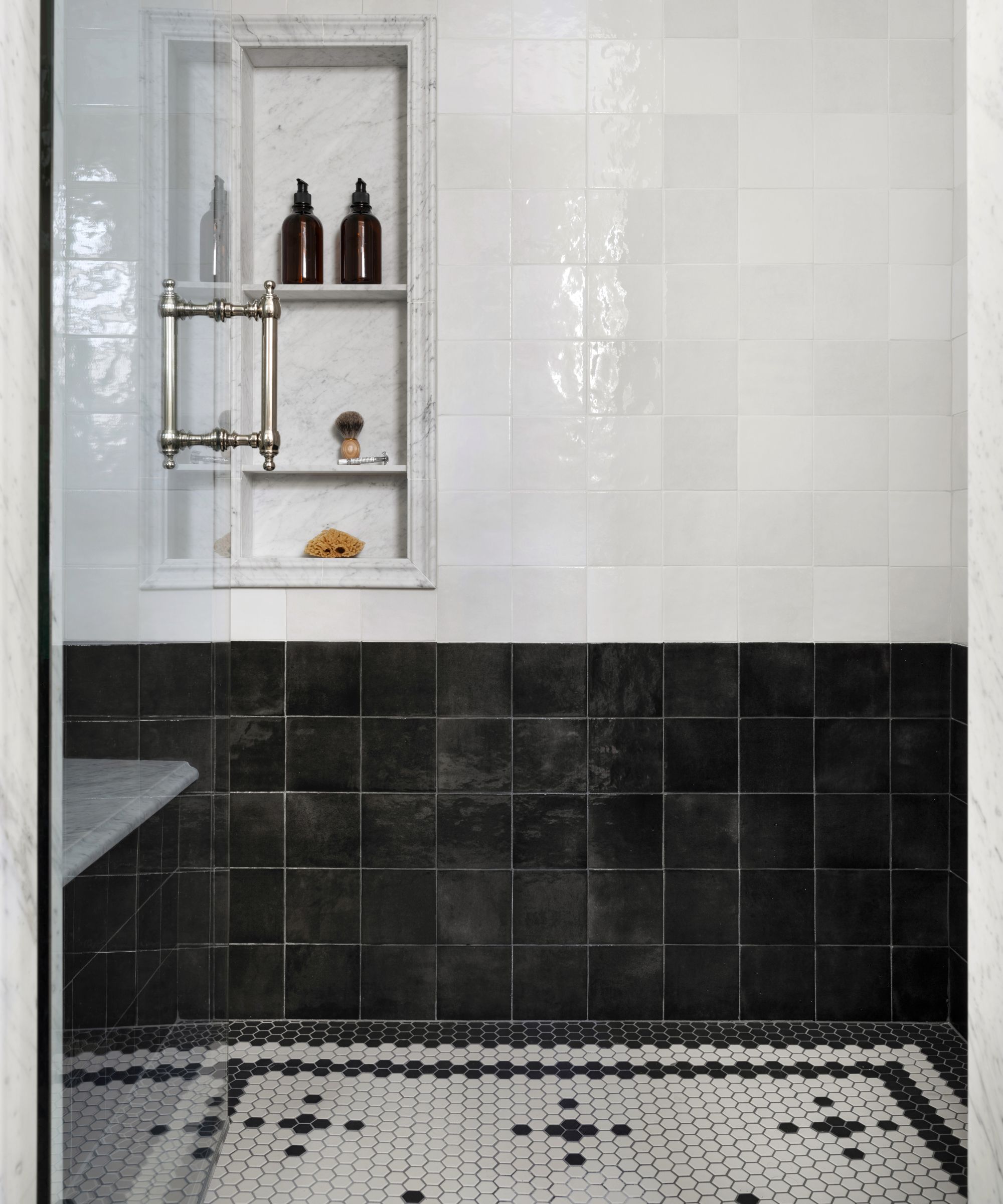 A black and white bathroom with hexagonal mosaic floor tiles