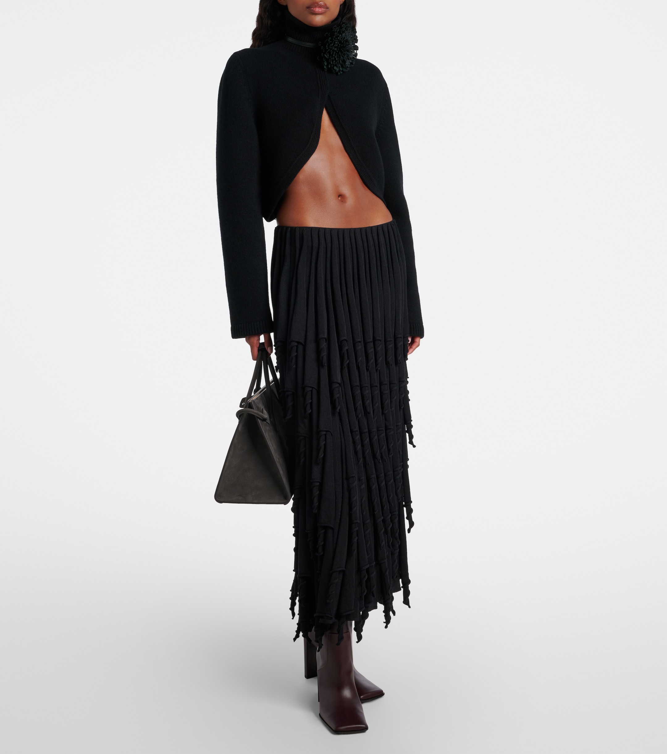 a model wearing alaia square toe heeled boots