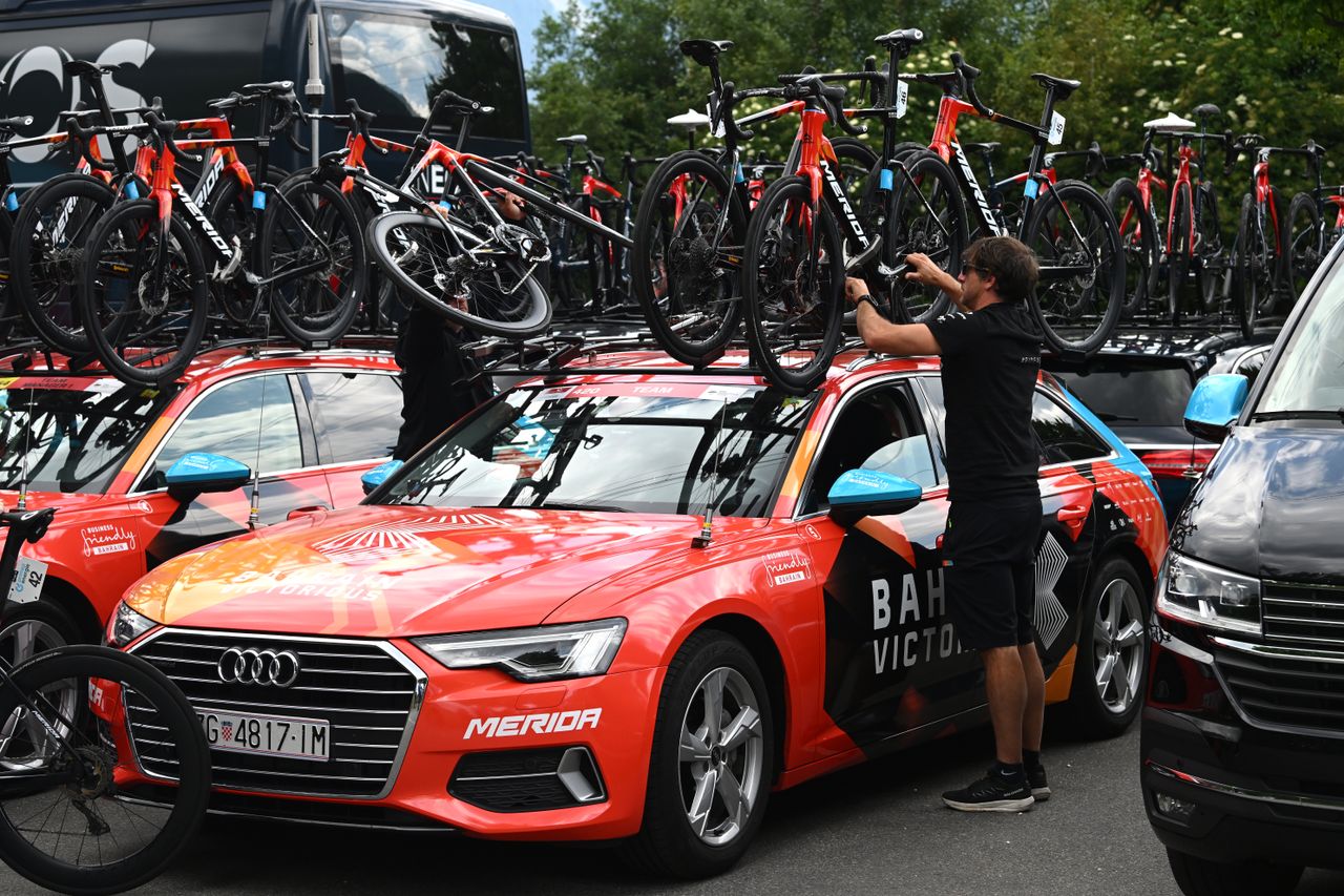 Bahrain Victorious bikes loaded onto team car by soigneurs