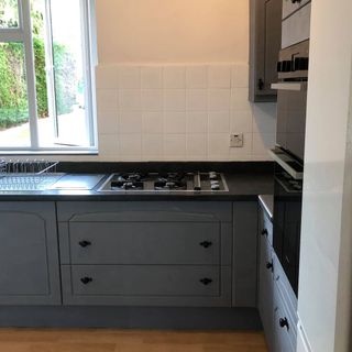 kitchen with wooden flooring and grey drawers