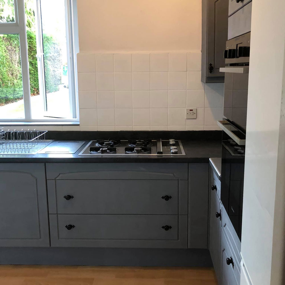 kitchen with wooden flooring and grey drawers