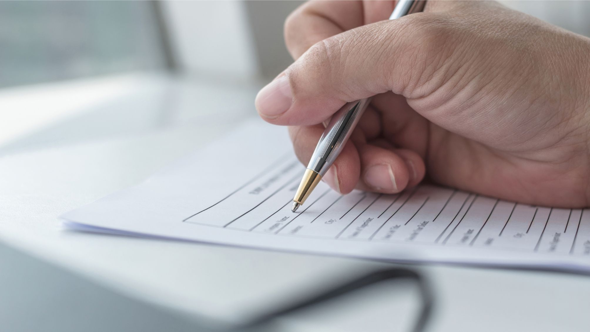 A person filling out a claim form.