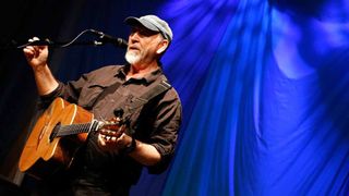Richard Thompson playing an acoustic guitar live