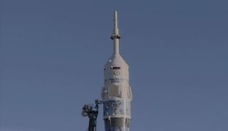 A Russian Soyuz rocket emblazoned with the 2014 Sochi Winter Olympics branding stands poised to launch the Olympic torch and Expedition 38 crew of the International Space Station from Baikonur Cosmodrome, Kazakhstan on Nov. 6, 2013 ET (Nov. 7 local time).