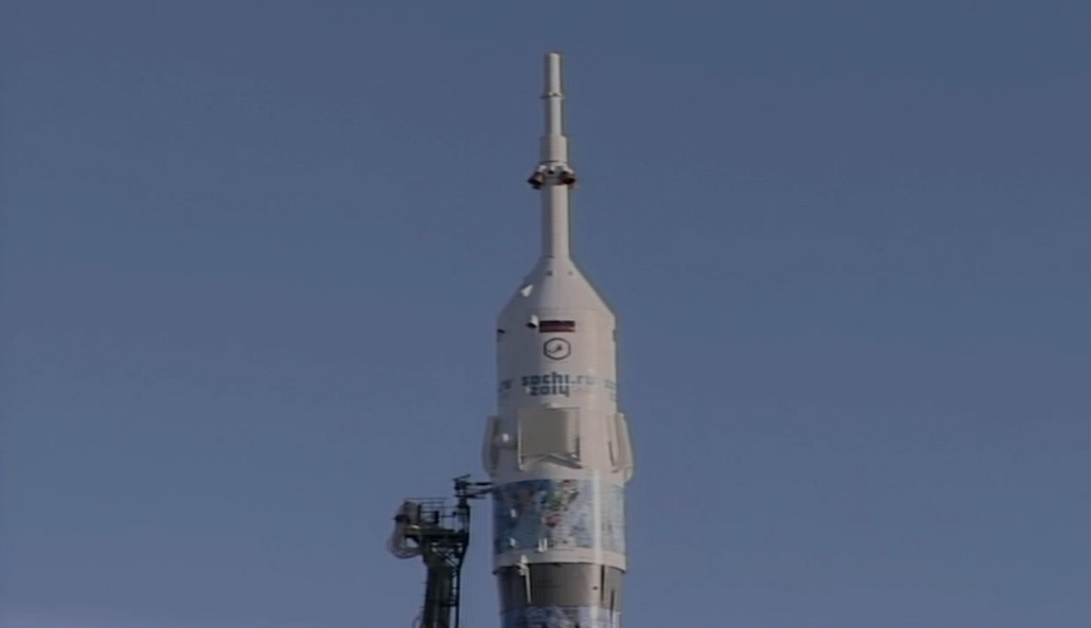 A Russian Soyuz rocket emblazoned with the 2014 Sochi Winter Olympics branding stands poised to launch the Olympic torch and Expedition 38 crew of the International Space Station from Baikonur Cosmodrome, Kazakhstan on Nov. 6, 2013 ET (Nov. 7 local time).