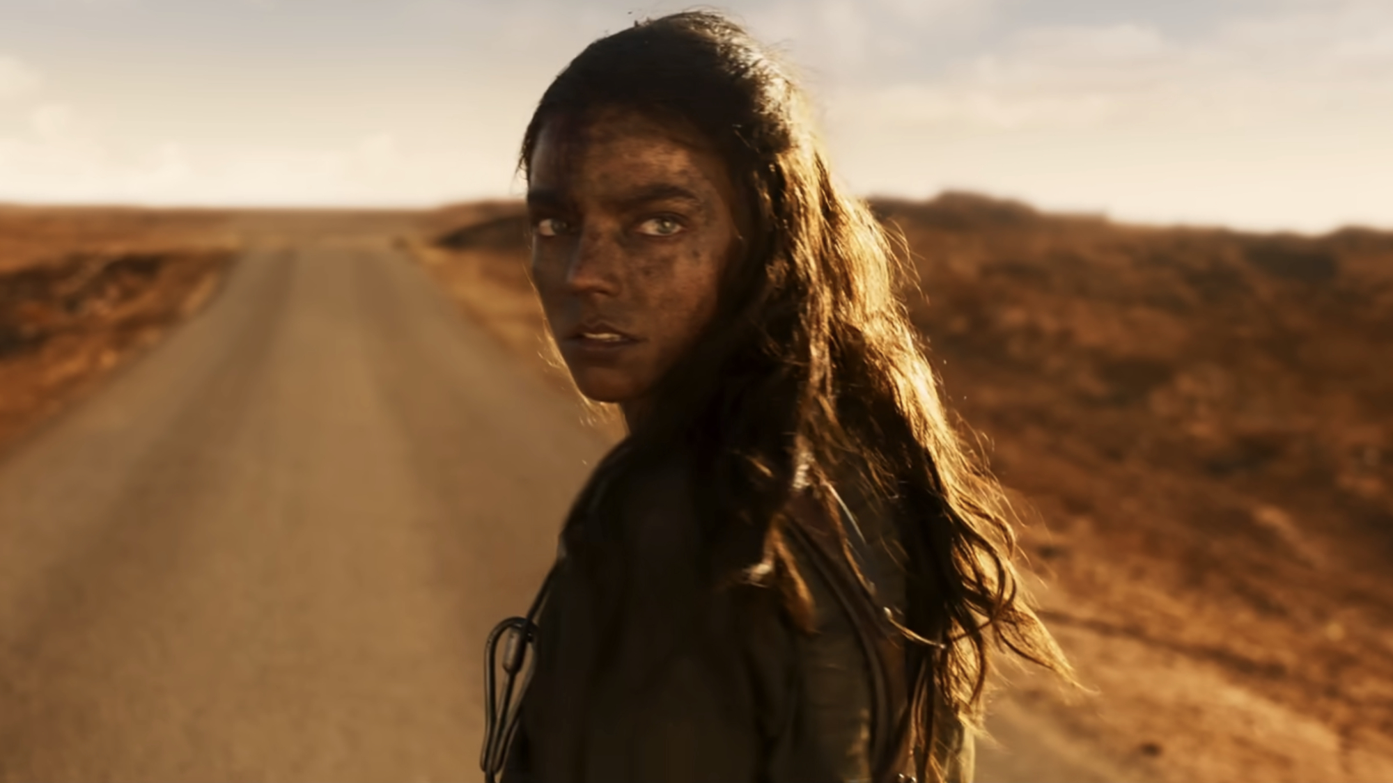 Furiosa (Anya Taylor-Joy) looks over her shoulder in Furiosa: A Mad Max Saga.
