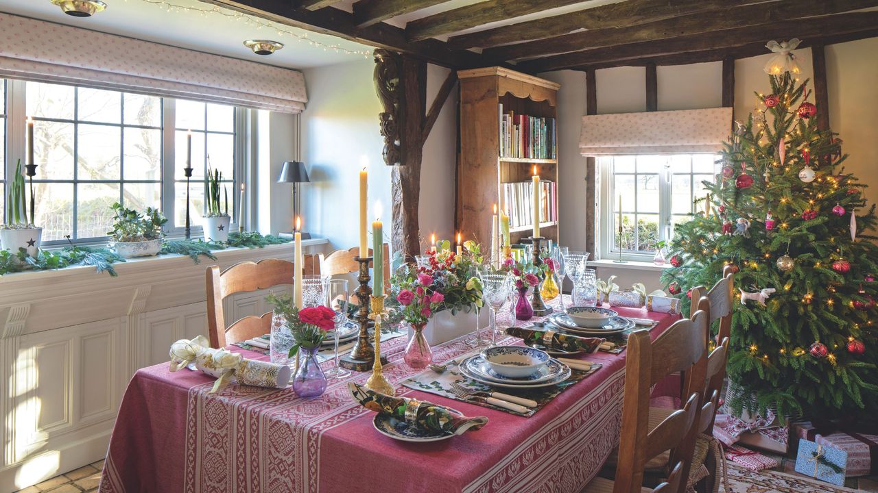 Decorated Christmas tree next to dining table with red tablescaping