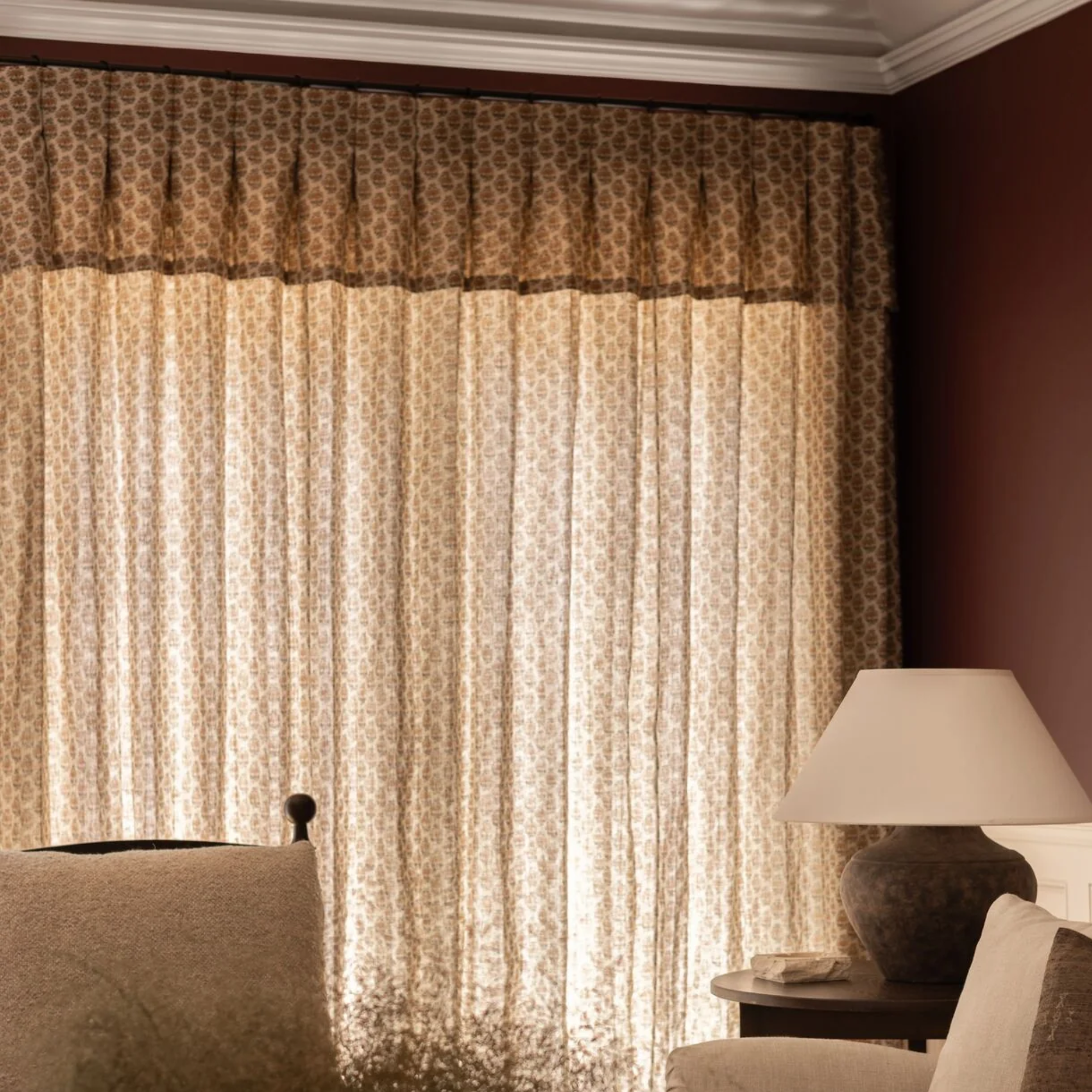a room with box pleat drapes in a repetitive floral pattern