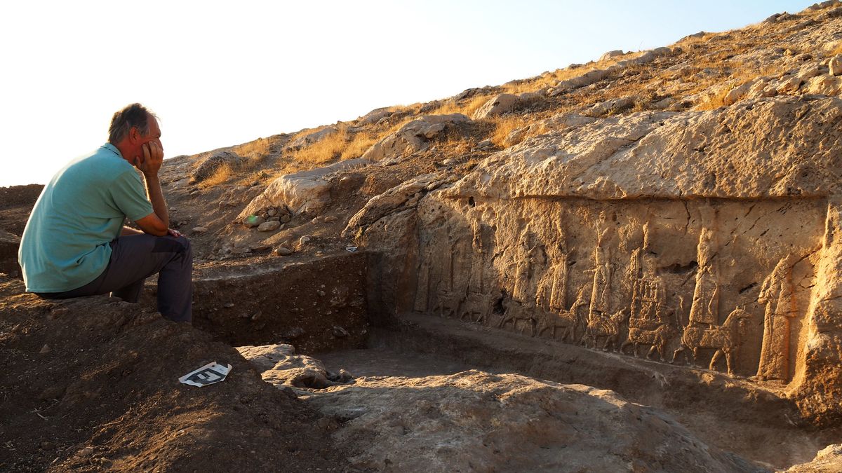 The leader of the excavation, archaeologist Daniele Morandi Bonacossi, and one of the panels of Assyrian carvings unearthed in the northern Kurdistan region of Iraq.